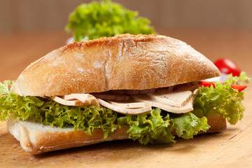 Tasty sandwiches with vegetables on a wooden table.