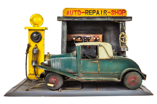 Retro toy car repair shop isolated on white