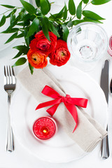 table setting with red flowers