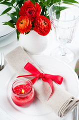 table setting with red flowers