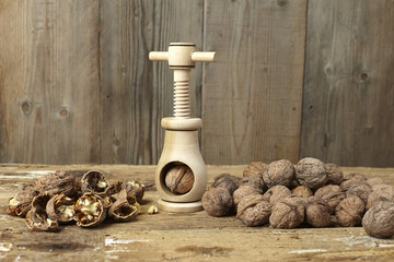 Obraz na płótnie Canvas walnuts cracked open with a vintage wooden nut cracker