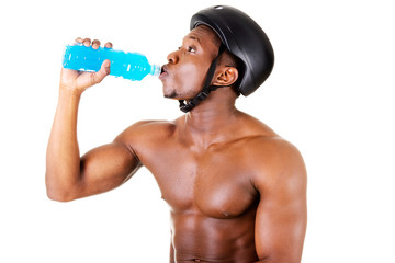 Handsome man drinking , wearing a bicycle helmet.