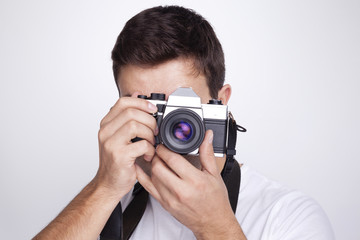 Photographer with camera against gray background