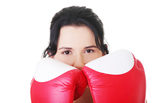 Attractive young woman with boxing gloves. Closeup.