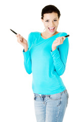 Attractive woman with two pens.