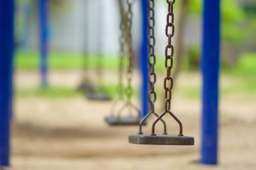 Row of chain swings on kids playground