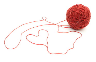 Heart shape and wool ball on white background
