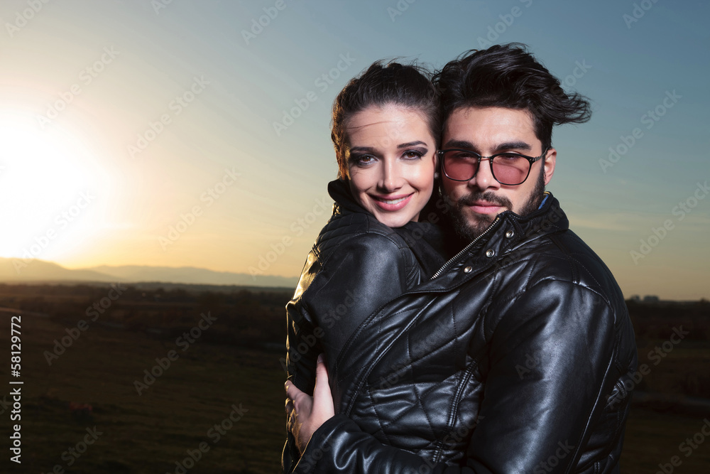 Canvas Prints in love couple standing embraced in the dawn and smile