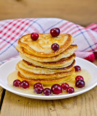 Flapjacks with cranberries and honey on the board