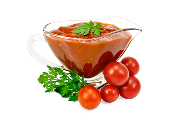 Ketchup in a glass gravy boat with tomatoes and parsley