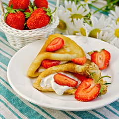 Pancakes with strawberries on a napkin