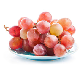 Red grape on the plate, closeup, isolated on white background