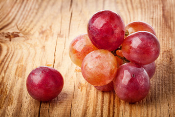 Red grape on wooden table, closeup