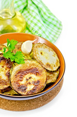 Zucchini fried in a ceramic bowl with a napkin
