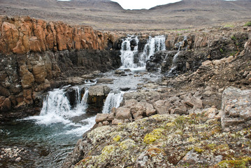 Landscape with rocks and a waterfall.