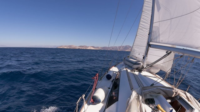 Sailing yacht on the race in blue sea