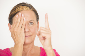 Mature woman testing focus of eyesight © roboriginal