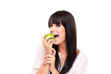 beautiful brunette woman with green apple on white background
