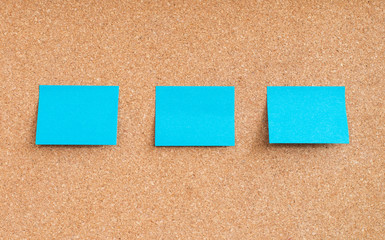 Blue sticky notes on cork board