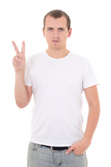 young attractive man in white  t-shirt shows a sign of "peace"