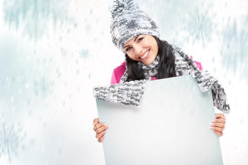 smiling girl with a blank board and around snowing