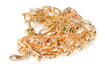 Isolated pile of gold jewelry on white background