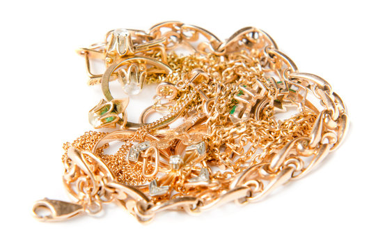 Isolated Pile Of Gold Jewelry On White Background