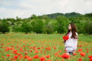 Fototapeta premium Ukrainian girl in poppy field