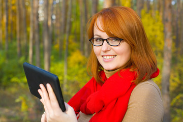 Obraz premium Portrait of beautiful red-haired girl in glasses