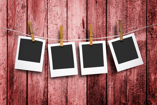Photos frames on rustic red wood background