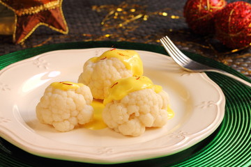 Steamed cauliflower with saffron sauce on a Christmas table
