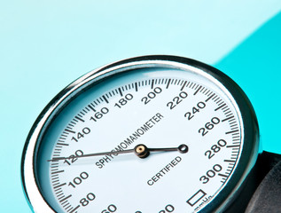 Sphygmomanometer on blue, reflective background