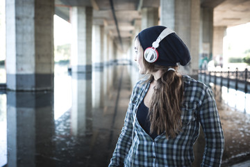 beautiful young blonde hipster woman listening music