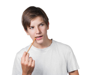 Schoolboy with a pencil in his mouth