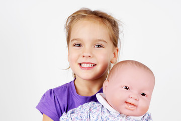 Little girl playing with doll