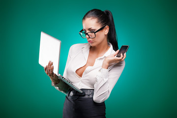 Young business woman with laptop and mobile