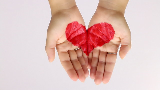 showing a painted heart with hands