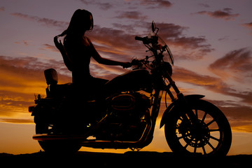 Silhouette of woman sitting on motorcycle © Poulsons Photography