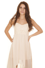 Woman white dress small smile stand