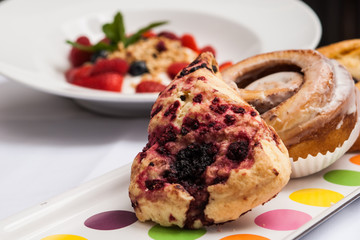 Strawberries, granola, blueberries and pastries