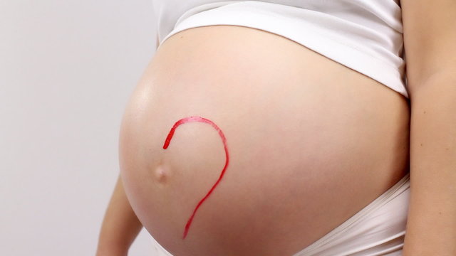 Painting of  heart on pregnant woman's belly