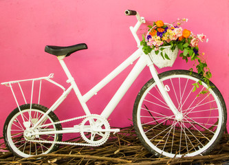 White bicycle on pink wall