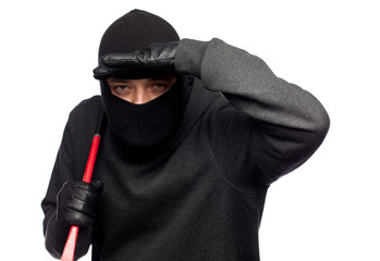 Burglar with a crowbar on the shoulder.