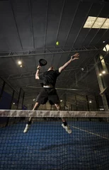 Gordijnen Paddle tennis player smashing, full length. © FotoAndalucia
