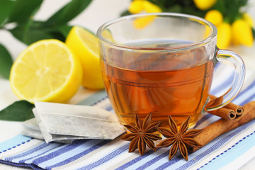 Tea, tea bags, fresh lemon, star anise and cinnamon sticks