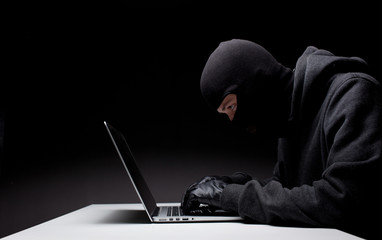 Computer hacker in a balaclava © Sergey Mironov