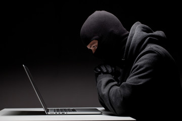 Computer hacker in a balaclava © Sergey Mironov