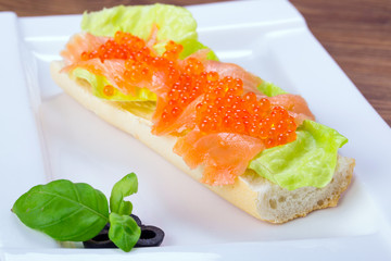 Red caviar and smoked salmon sandwich