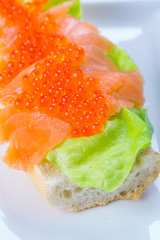 Red caviar and smoked salmon sandwich