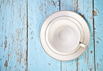 tea cup and saucer on wooden boards top view